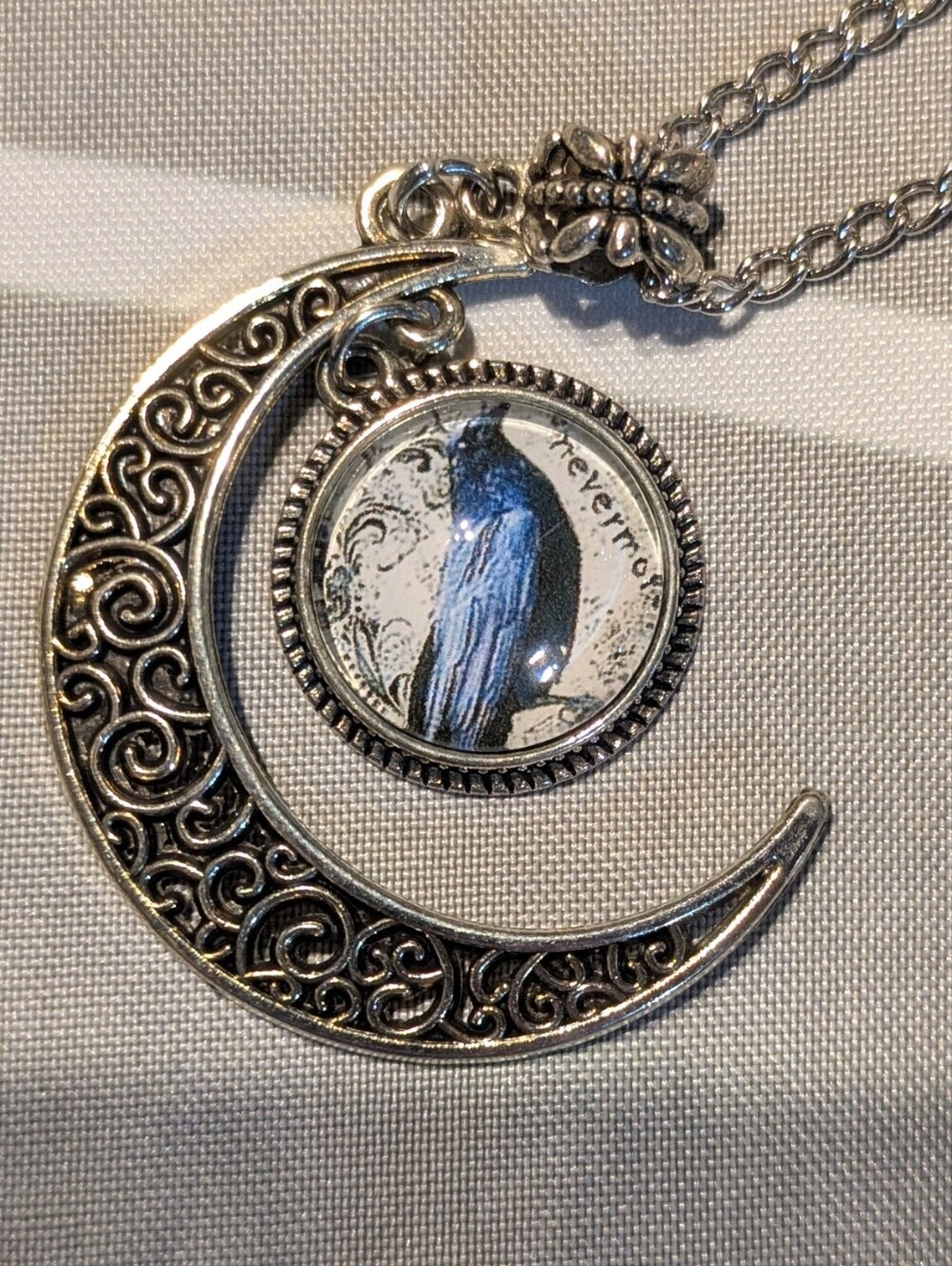Silver Crescent Moon Necklace with Blue Raven Pendant